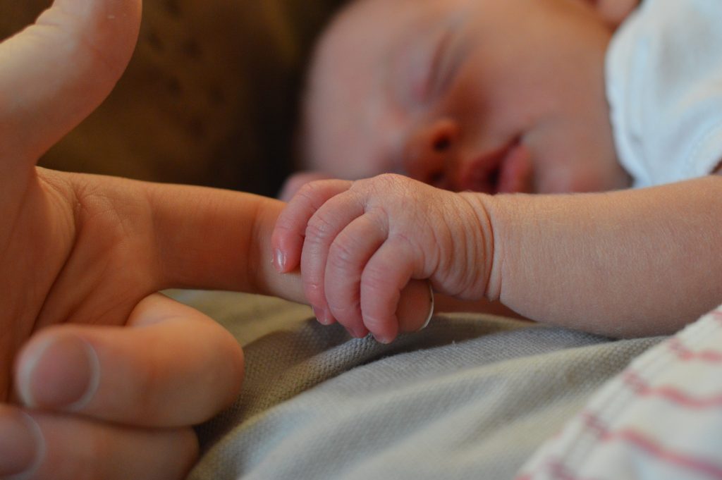 Baby holding human finger 225744