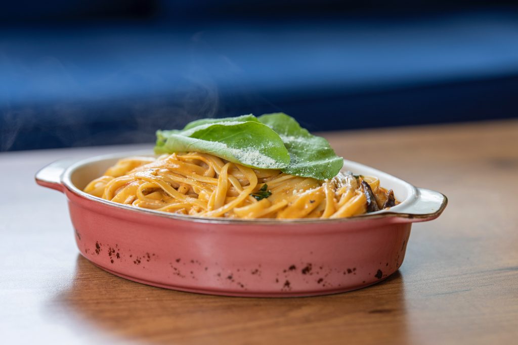 Pasta with basil leaves on top 3209100